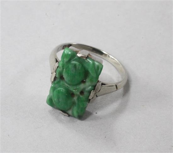 A 9ct white gold and carved jadeite plaque ring, size N.